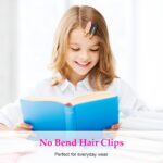 Set of six D creaseless hair clips in black, pink, and white with golden handles, arranged on a surface.