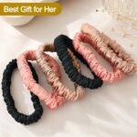 Set of six DEMAZALO silk hair scrunchies in black, coffee brown, and rose pink, neatly arranged.