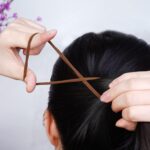 A close-up view of a pile of black, seamless, thick elastic hair ties, suitable for ponytails and various hairstyles.