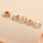 Close-up of 20 gold metal alloy hair braid clips and non-piercing ear clips in various decorative styles.