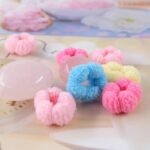 A pile of WDGROW mini hair ties in various bright colors, suitable for babies and toddlers.